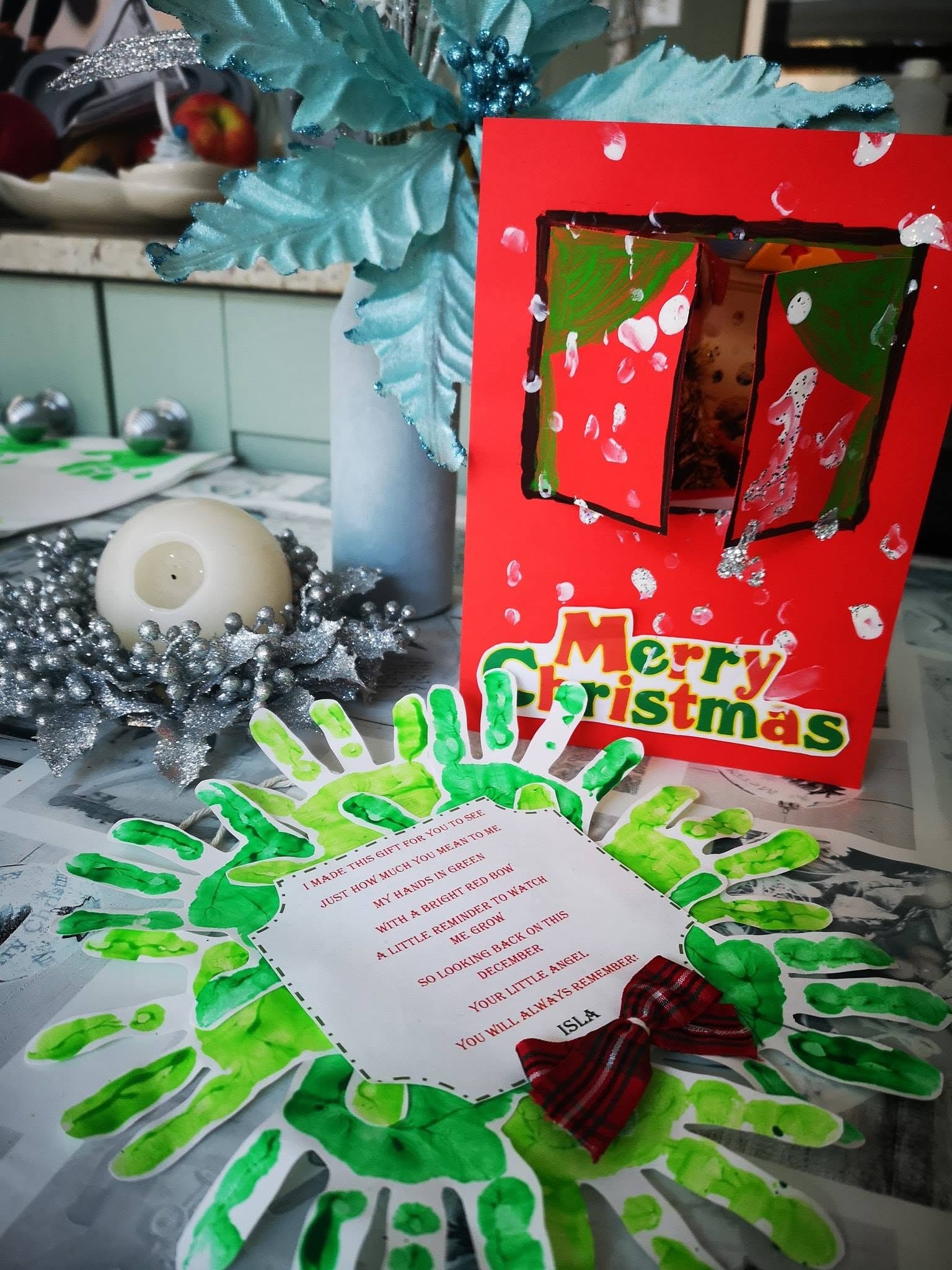 A handmade Christmas card and painted handprint keepsake